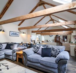 A living room with a sofa and coffee table at Cider Press Cottage in Torpoint