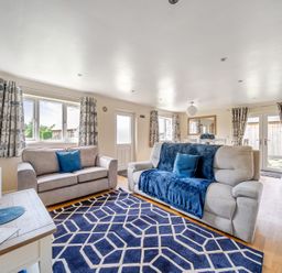 A living room with sofas and a table at Lodge 4 Near Brigg