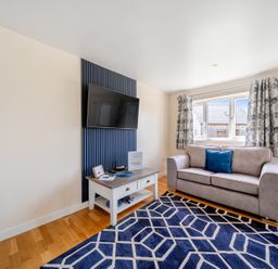 A living room with a sofa and a television at Lodge 4 Near Brigg