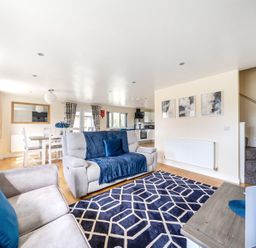 A living room with a sofa and dining area at Lodge 4 Near Brigg