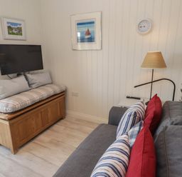A living room with a sofa and television at The Bolthole in Newport