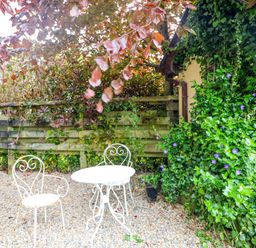 A garden area with a table and chair at The Mews @ Derrybawn, Laragh, County Wicklow
