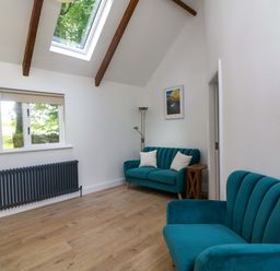 A living room with two sofas and a window at The Mews @ Derrybawn, Laragh, County Wicklow