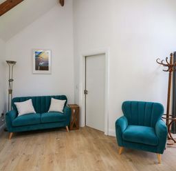 A living room with a sofa and chair at The Mews @ Derrybawn in Laragh, County Wicklow