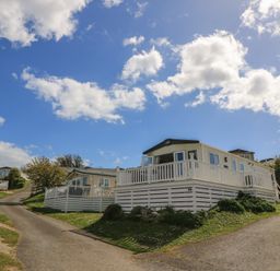Mobile homes on a hillside with a pathway at Swanny View in Swanage