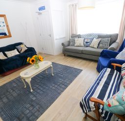 A living room with a sofa and a coffee table at 3 Edward Street in Tenby