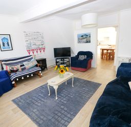 A living room with a television and seating area at 3 Edward Street in Tenby
