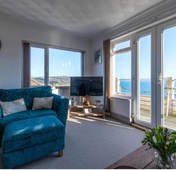 A living room with a sofa and television at 1 Bed Flat - Sleeps 2 - Pets - Balcony - Parking in Looe