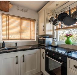A kitchen with a sink, kettle, and pots at 1 Bed Flat - Sleeps 2 - Pets - Balcony - Parking in Looe