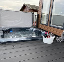 A hot tub with a bucket of drinks at Yorkshire view lodge Wilberfoss
