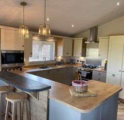 A kitchen with appliances and an island at Yorkshire view lodge in Wilberfoss