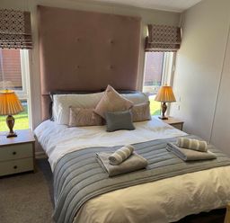 A bedroom with a double bed and bedside tables at Yorkshire View Lodge in Wilberfoss