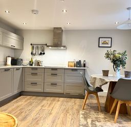A kitchen with sink and table at Cottage - Sleeps 2 - Garden in Coleford