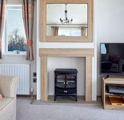 A living room with a fireplace and television at 2 Bed Lodge Sleeps 4 - Pet Welcome - Fireplace, Cirencester