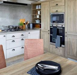 A kitchen with stove, oven, cabinets and dining table at 2 Bed Lodge Sleeps 4 - Pet Welcome - Fireplace, Cirencester