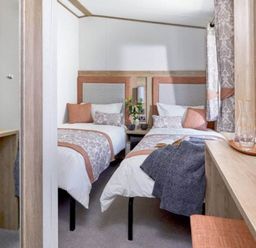 A bedroom with two beds and a mirror at 2 Bed Lodge Sleeps 4 - Pet Welcome - Fireplace Cirencester