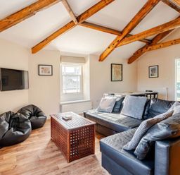 A living room with a sofa and coffee table at Sedbergh Penthouse - KingBed - Tv - Wifi Sedbergh