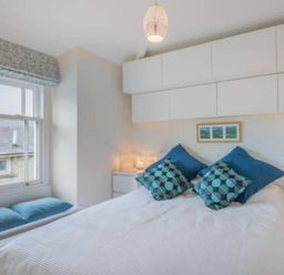 A bedroom with a bed and bedside tables at Sedbergh Penthouse - KingBed - Tv - Wifi Sedbergh