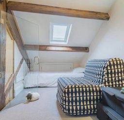 A loft area with a sofa bed and bed at Sedbergh Penthouse - KingBed - Tv - Wifi Sedbergh
