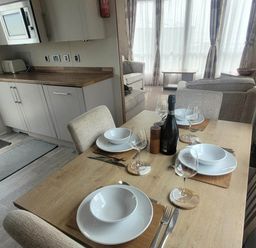 A dining room with a table set for four at Beachside Lodge - Sleeps 6 - Pets ok - Parking Heysham