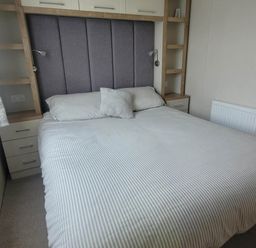 A bedroom with a bed and bedside storage at Beachside Lodge - Sleeps 6 - Pets ok - Parking Heysham