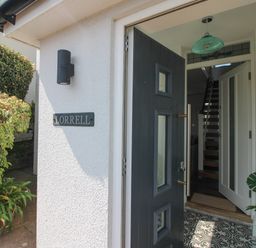 An entrance with a door and staircase at Lorrell in Salcombe