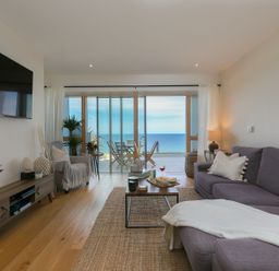 A living room with a sofa and coffee table at Anchors Rest in St. Ives