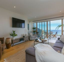 A living room with a television and sofa at Anchors Rest in St. Ives
