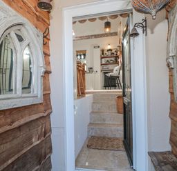 An entryway with stairs leading to a kitchen at 7 The Cedars Wotton-Under-Edge