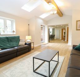 A living room with sofas and a coffee table at Bramley Cottage in Worlingham