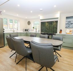 A kitchen with dining table and chairs at Bramley Cottage in Worlingham