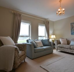 A living room with chairs and a table at An Grianan Getaway in Burt