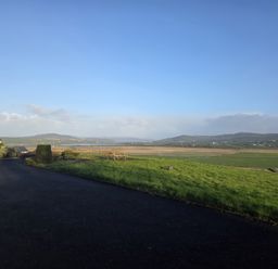 A view of fields and hills from a property at An Grianan Getaway in Burt