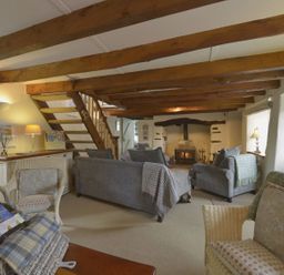 A living room with sofa and fireplace at Mays Cottage in Wadebridge