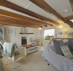 A living room with a sofa and armchairs at Mays Cottage Wadebridge