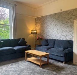 A living room with two sofas and a coffee table at Apartment 5 in Torquay