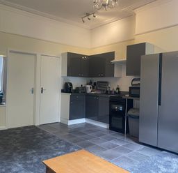 A kitchen with cabinets and appliances at Apartment 5 in Torquay