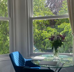 A dining area with a table and flowers at Apartment 6 in Torquay