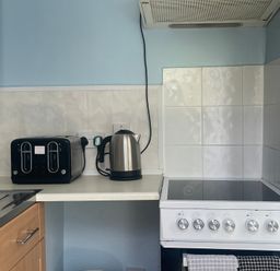 A kitchen with a toaster and kettle on the countertop at Apartment 6 in Torquay