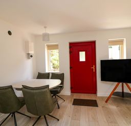A dining room with a table and chairs at The Mews @ Suskar, Laragh, County Wicklow