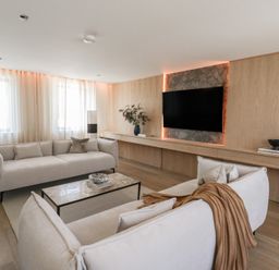 A living room with sofas and a television at Brynseion Uchaf near Aberystwyth