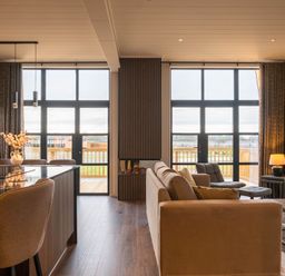 A living room with a sofa and dining area at Exclusive Tempest Spa in Grimsby