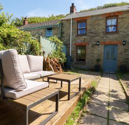 A garden with seating and pathway at 18 Tregea Terrace in Portreath