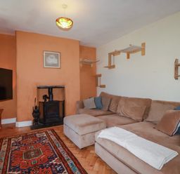 A living room with a sofa and television at 18 Tregea Terrace in Portreath