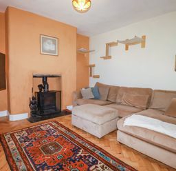 A living room with a TV and a sofa at 18 Tregea Terrace in Portreath