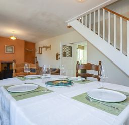 A dining room with a table set for dining at 18 Tregea Terrace in Portreath