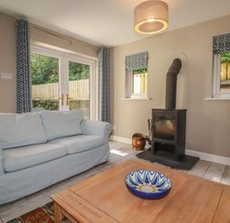 A living room with a sofa and coffee table at Stowaway Cottage Padstow