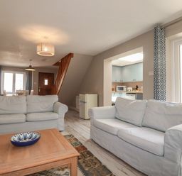 A living room with sofas and a coffee table at Stowaway Cottage in Padstow