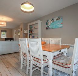 A dining room with a table and chairs at Stowaway Cottage in Padstow