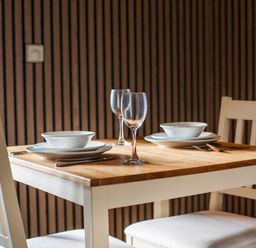 A dining table set with plates and glasses at Pine Lodge Spa in Carlton Miniott near Thirsk